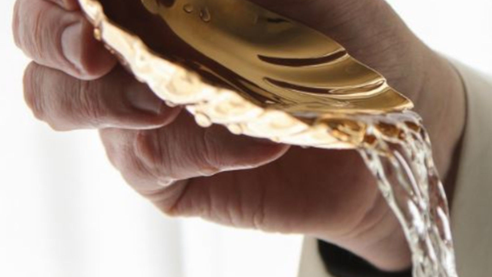 holy water being poured for baptism