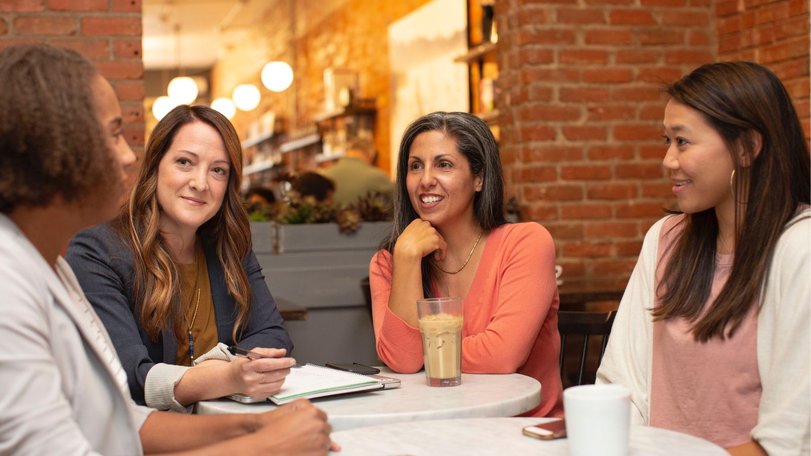 adults sitting around a table talking