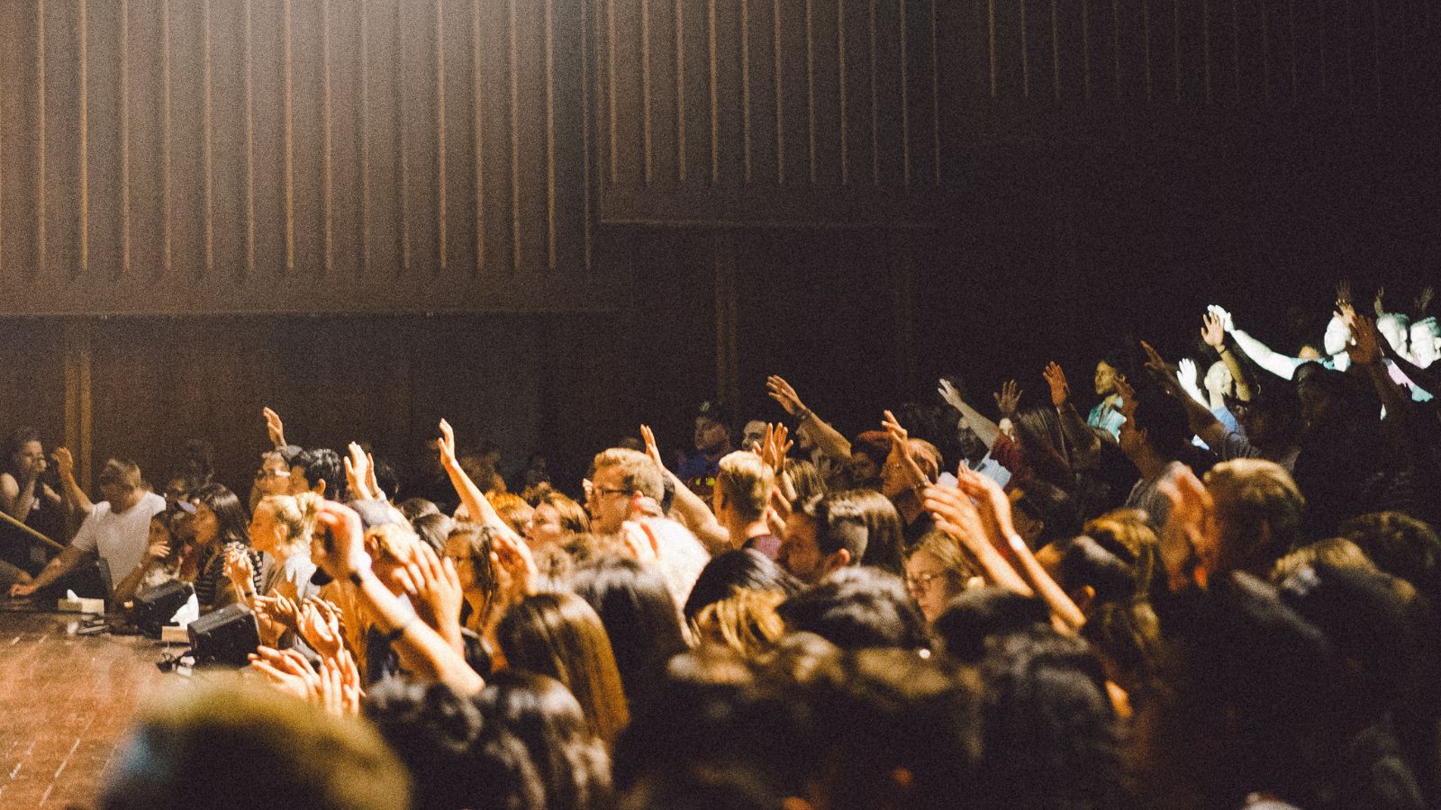 teens lifting hands for praise and worship